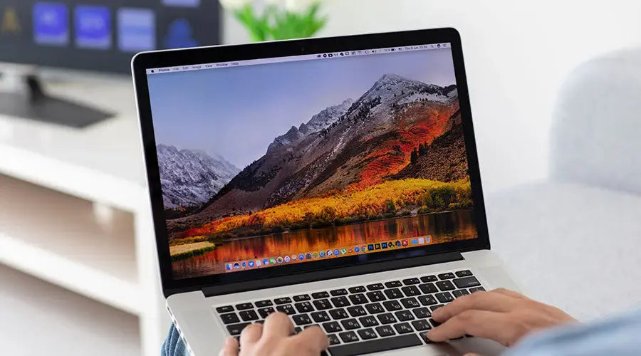 Customer examining MacBook Pro features before purchase at PayMore Rockville