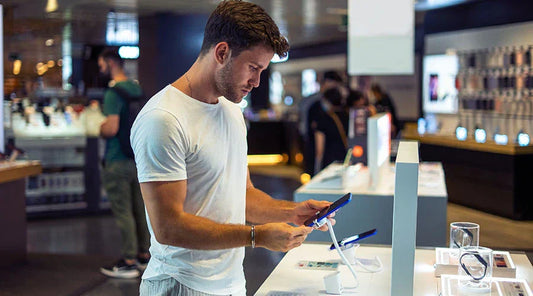 PayMore Rockville staff evaluating a smartphone before purchase.